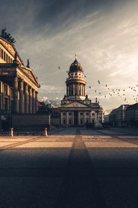 Walkway leading towards historic building in city