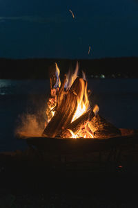 Bonfire on log at night