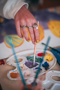 Midsection of man painting on table