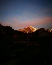 Scenic view of mountains against sky at night