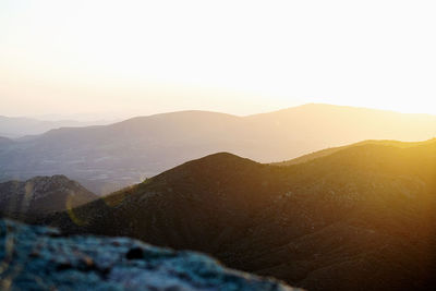 Scenic view of mountains against clear sky during sunset