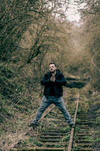 Full length of man standing on the railway 