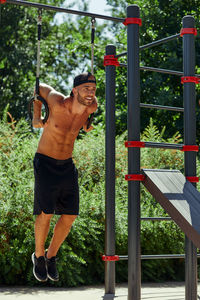 Rear view of man standing on railing