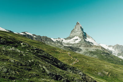 Scenic view of mountains against clear blue sky