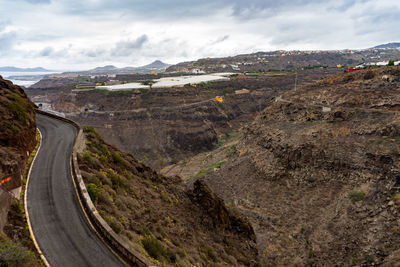 High angle view of road amidst mountains against sky