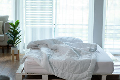 Midsection of man relaxing on bed at home