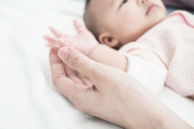 Close-up of baby sleeping on bed