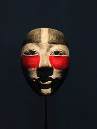 Close-up of mask against black background