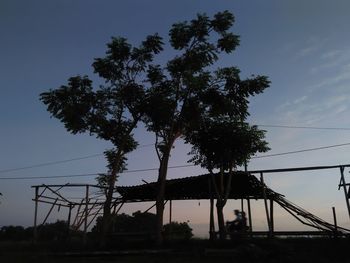 Low angle view of silhouette tree against sky