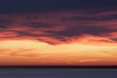 Scenic view of dramatic sky over sea during sunset