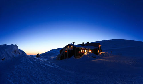 Illuminated house at winter