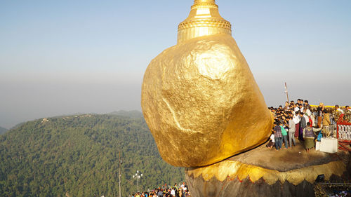 People at temple against sky