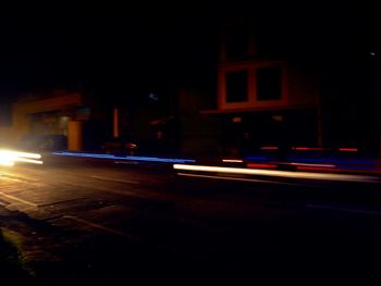 Light trails on road in city at night