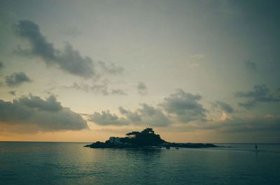 Silhouette of boat in sea at sunset