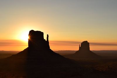 Monument valley against sky during sunset