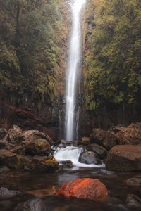 25fontes waterfall rises in the mist and rain on the island of madeira, portugal. 