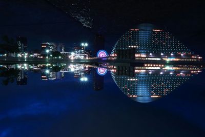 Reflection of illuminated buildings in calm river