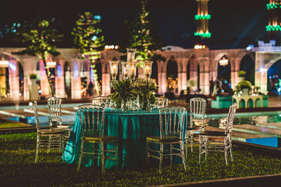 Empty chairs and tables in restaurant at night