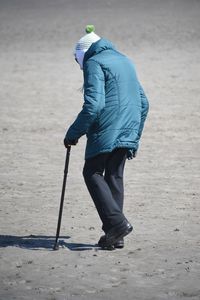 Rear view of man walking on beach