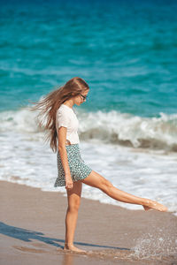 Young woman standing at beach