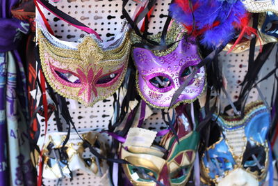 Close-up of venetian masks hanging for sale