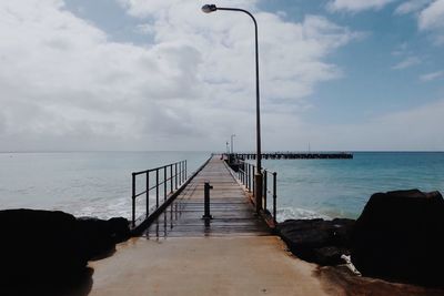 Pier over sea against sky