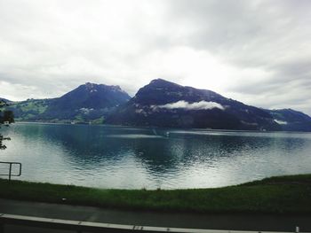 Scenic view of lake against cloudy sky