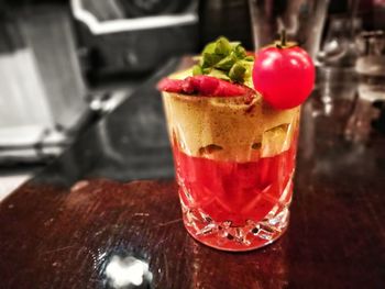 Close-up of served ice cream with juice on table