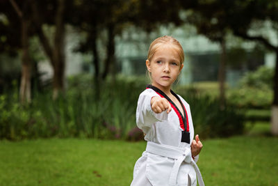 Portrait of boy standing on field