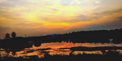 Scenic view of lake against romantic sky at sunset