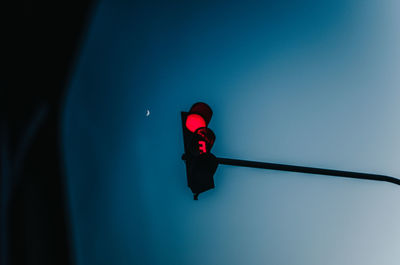 Low angle view of road signal against blue sky
