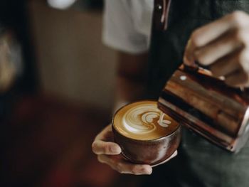 Midsection of woman holding coffee