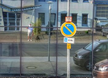 Road sign against buildings in city