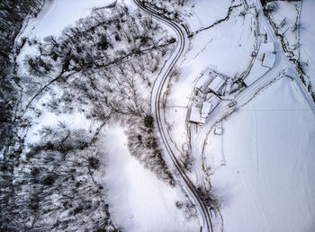 High angle view of road amidst trees during winter