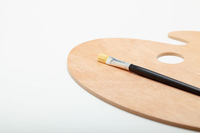 High angle view of piano on table against white background