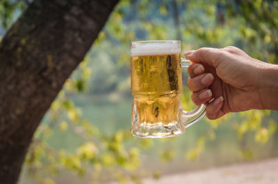 Hand holding glass of beer