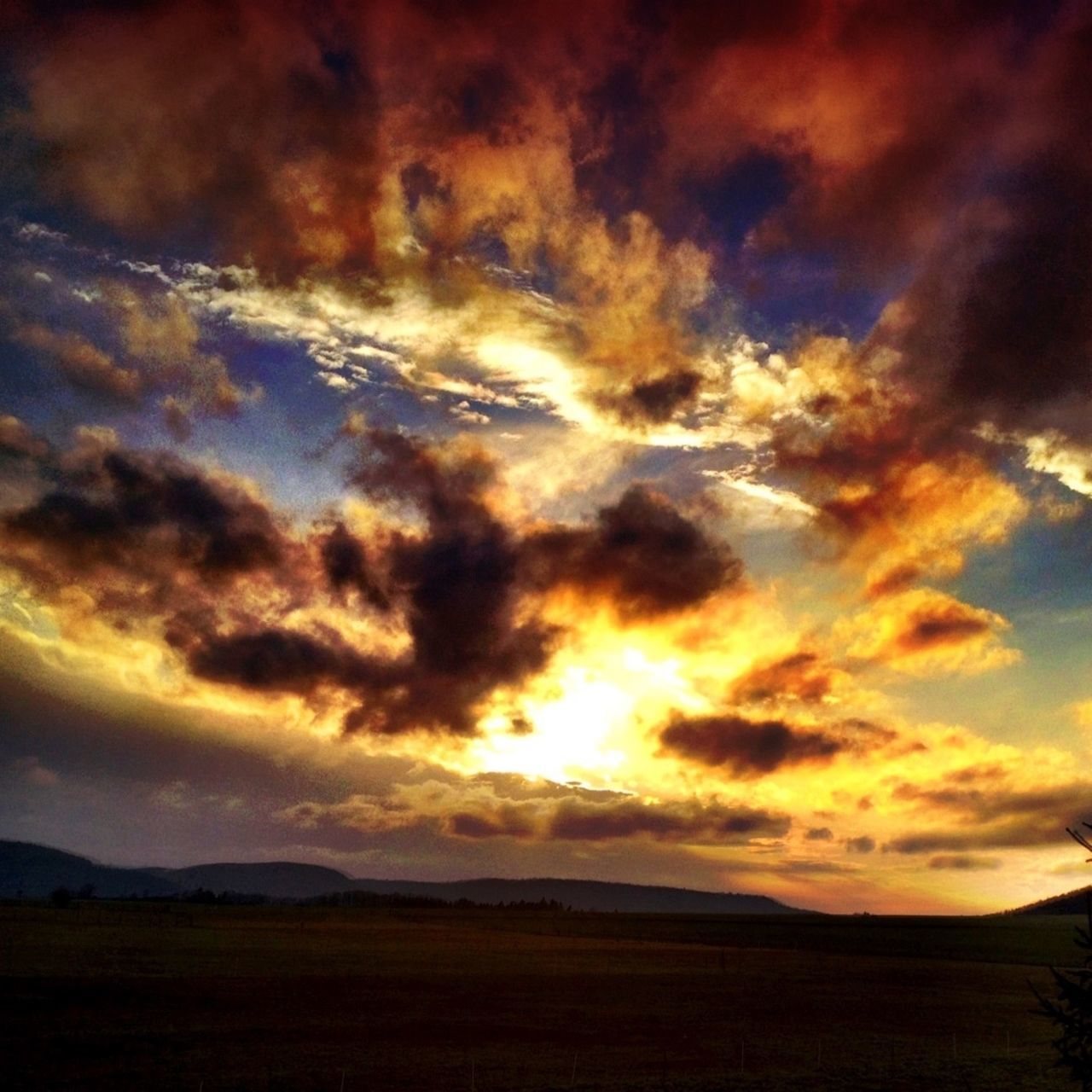 sunset, tranquil scene, sky, scenics, tranquility, beauty in nature, landscape, silhouette, cloud - sky, dramatic sky, orange color, nature, idyllic, cloud, cloudy, majestic, field, non-urban scene, horizon over land, moody sky