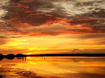 Scenic view of lake against romantic sky at sunset