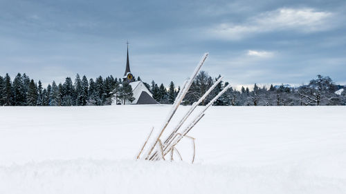 Snow on field against sky during winter