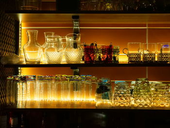 Glass of bottles on display at bar