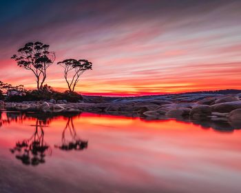 Scenic view of sea against romantic sky at sunset