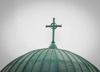 Low angle view of cross against sky
