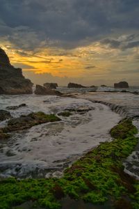 Scenic view of beach against sky during sunset