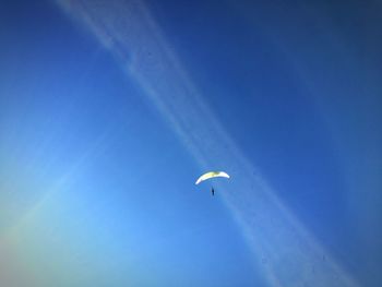 Low angle view of kite flying against blue sky