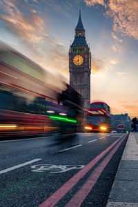 Blurred motion of vehicles on road at sunset