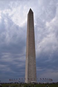 Low angle view of monument against cloudy sky