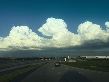 Cars on road against sky