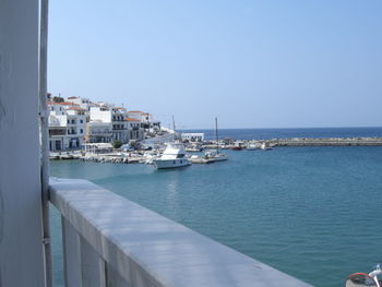 Boat in sea against clear blue sky