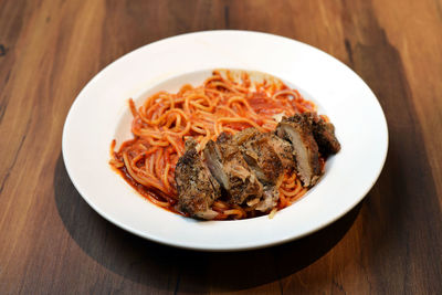 Close-up of chicken and noodles on plate