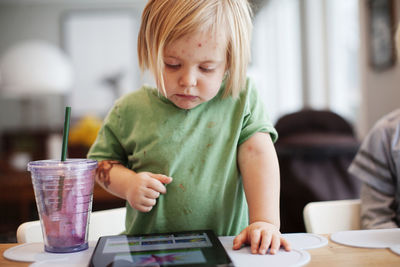 Girl playing with digital tablet
